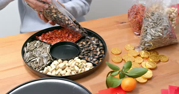 Woman fill with chinese new year snack tray