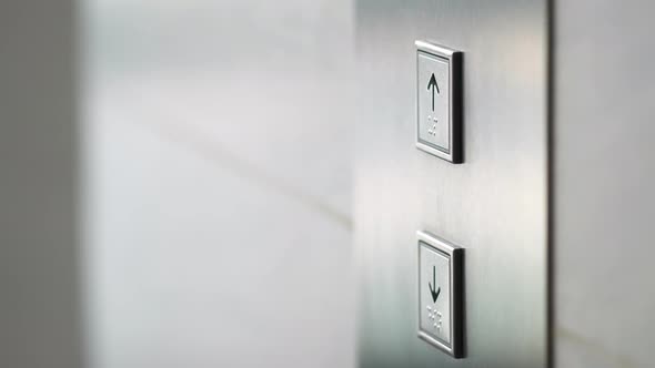 Man Pushing Elevator Button in Modern Building. Male Finger Pressing Lift Button Up.  Slow Motion.