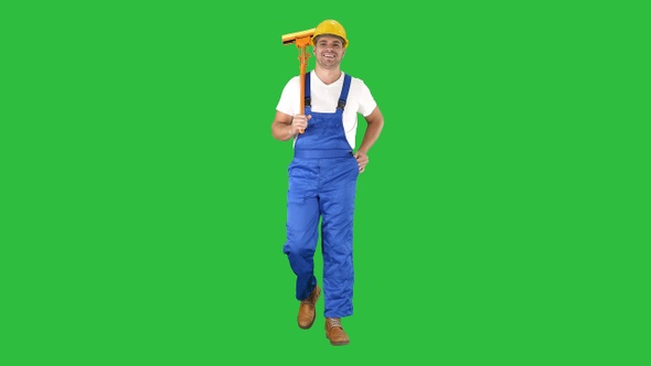 Housecleaner in helmet walking with a mop on a Green Screen