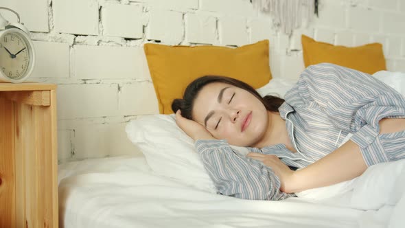 Portrait of Beautiful Asian Lady Sleeping in Bed Alone Wearing Pajamas