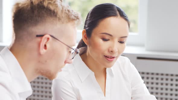 Diverse team of young professionals is working in the phone support office.