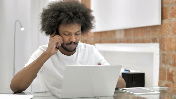 African Man Talking on Phone, Discussing