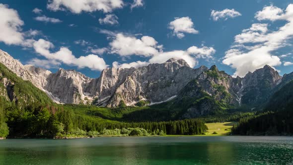 Alpine Italy. Landscape with Mountain Lake, Forest, Mountains and Clouds. Time Lapse