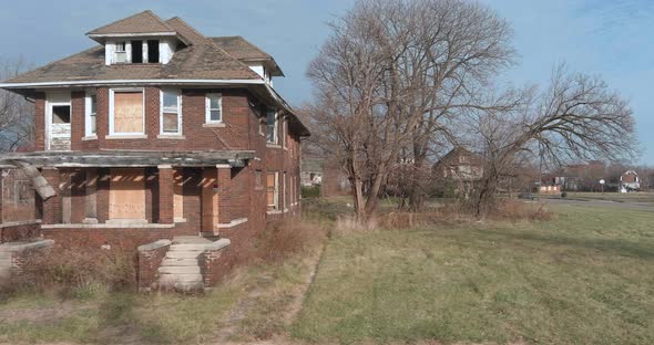 Aerial view of dilapidated house in a neighborhood in the city of Detroit, Michigan. This video was