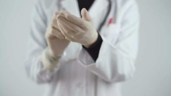 Scientist Female Putting Gloves in the Lab. Coronavirus Disease Prevention