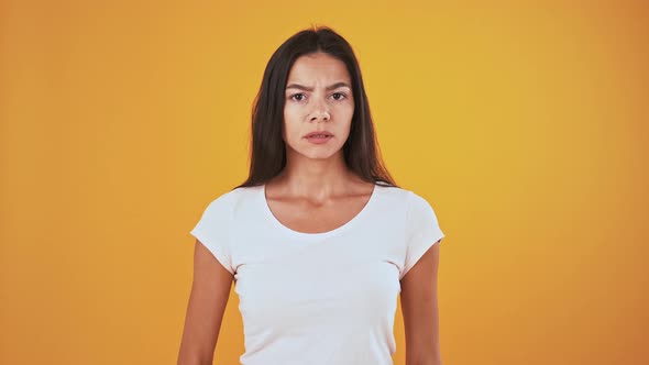 Serious Female Looking Around Showing Be Quiet Sign