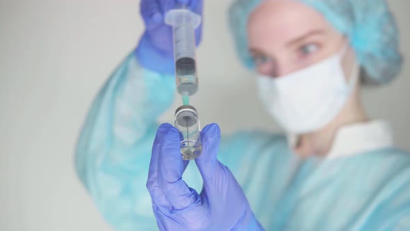Doctor draws medicine into a syringe