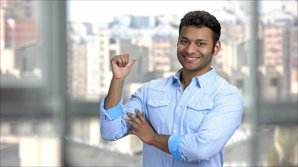 Handsome Young Indian Man Pointing Back