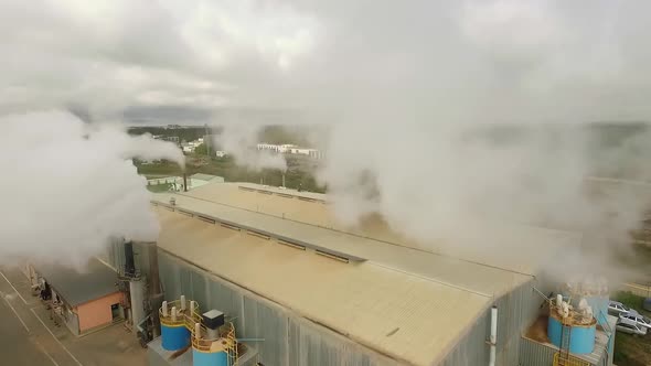 Aerial view of factory with pipes with white smoke emission 01