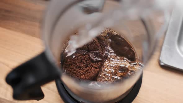 Steaming Hot Water Poured Onto Fresh Coffee in French Press