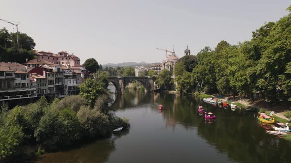 Beautiful cityscape with old medieval stone bridge of Amarante town, aerial drone view