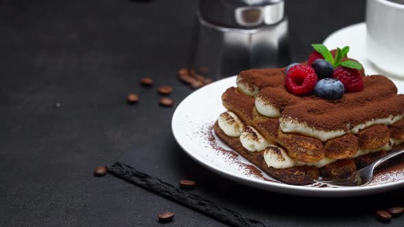 Tiramisu Dessert with Raspberries and Blueberries, Espresso and Coffee Maker on Concrete Background