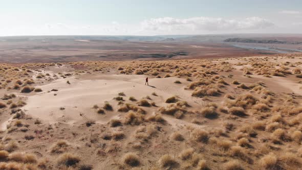 Aerial Shot of People Running at Sand Dunes in Kazakhstan