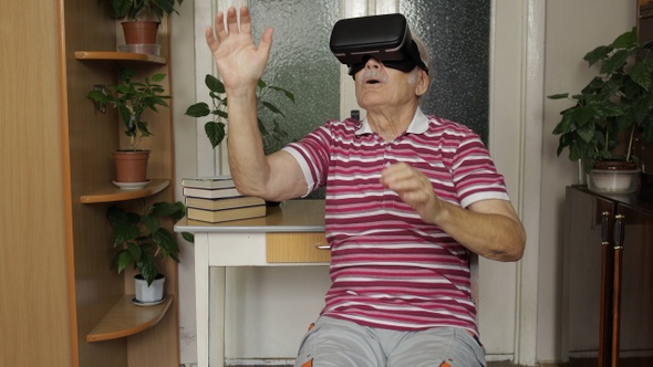 Senior Grandfather Putting on Virtual Headset Glasses and Watching 3d Video in 360 Vr Helmet at Home
