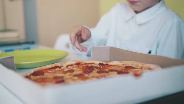 Schoolboy in Shirt Has Lunch with Pizza at Table Slow Motion