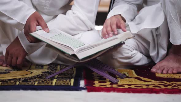 Muslim men reading Quran