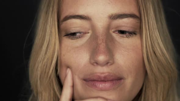 Slow motion shot of woman thinking and then looking up in surprised joy