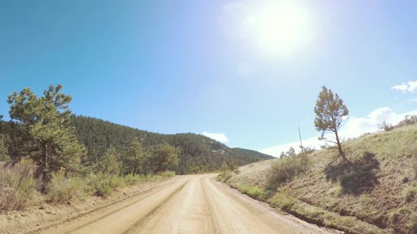 POV point of view -Driving on mountain dirt road in the Spring.