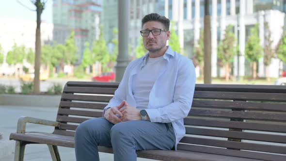 Man Standing and Leaving After Sitting on Bench Outdoor