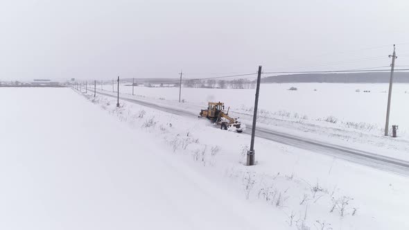 Aerial view of Snowblower Grader Clears Snow Covered Country Road 04