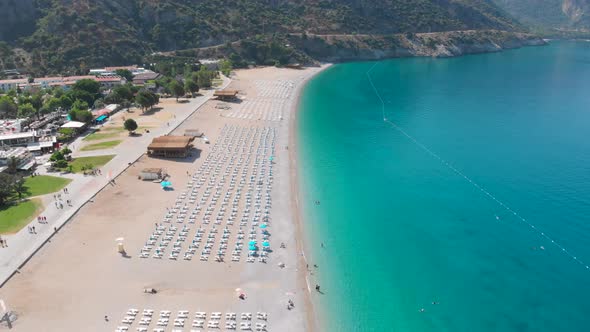 4k Aerial view of Oludeniz beach and boats, Yacht stationed on the beach in Fethiye Turkey, Summer v