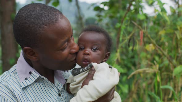 Father holding and kissing his little baby