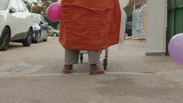 Homeless Man Out on the Streets with His Belongings in a Trolley