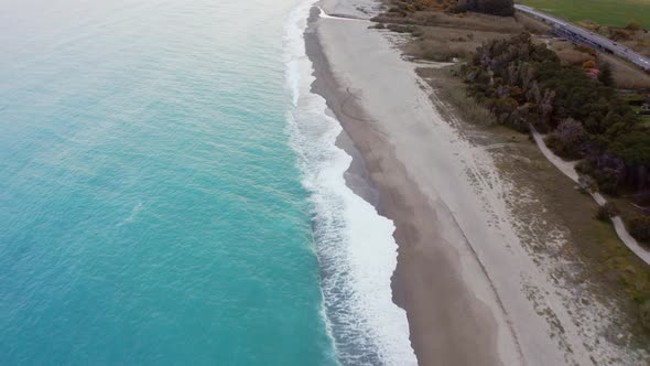 Aerial view sandy beach with white waves