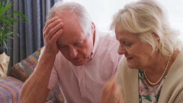 Senior couple in social distancing do administrative work.