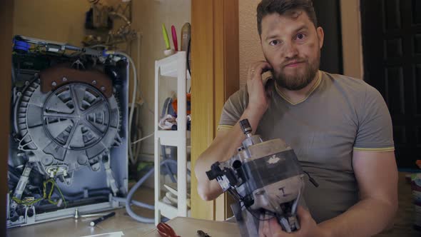 Middleaged Man Tired of Repairing His Home Washing Machine on His Own