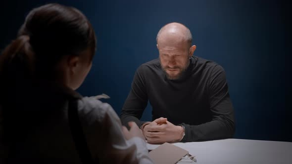 Female Detective Interrogates Suspected Criminal in Handcuffs