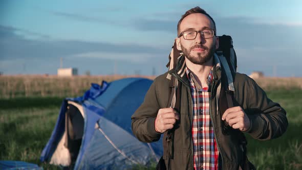 Active Male Backpacker Standing in Field with Tent Camping Enjoy Trip