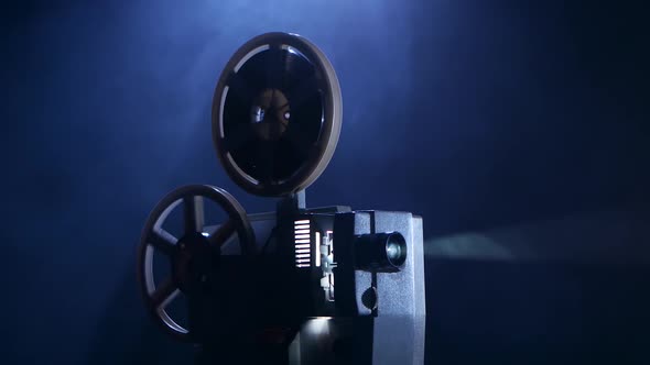 Film Rotates Reels and Vintage Shows Movie. Smoky Dark Studio