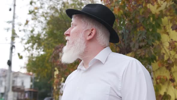 Close Up of an Older Man with Albinism in White Shirt and Hat