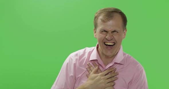 Handsome Young Man in Pink Shirt Laughing. Chroma Key