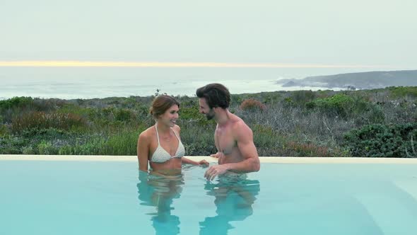 Couple wading in pool