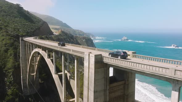 Aerial Footage of Car Crossing the Bixby Canyon Bridge Across the Mountains