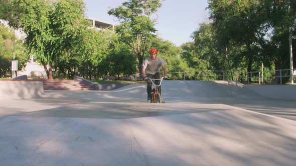 BMX Rider Doing Tricks in Cocncrete Skatepark Slow Motion