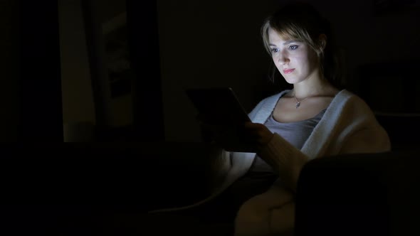 Woman Using Tablet Computer at Night