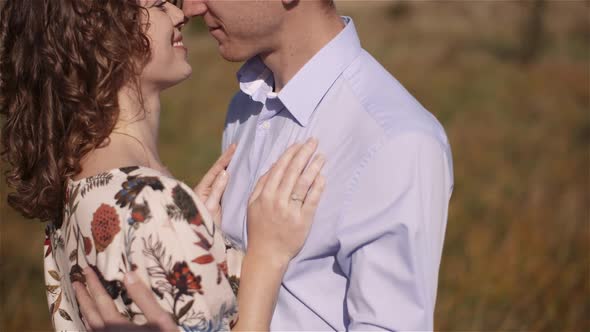 Young Couple in Love Walking on Meadow in Summer - Togetherness Concept