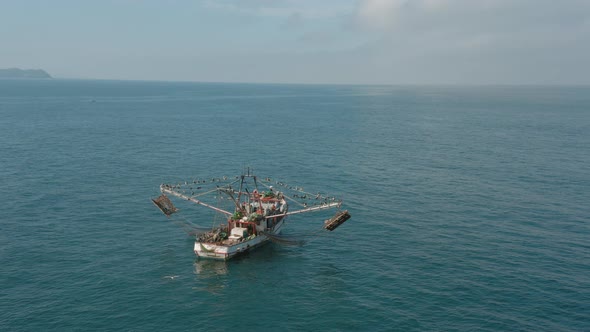 Small traditional Mexican boat in Pacific Ocean, fishermen and pelican