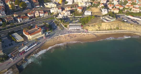 Aerial, drone shot over waves on a rocky coast, heading towards São João (Tamariz) beach, in Sao Joa