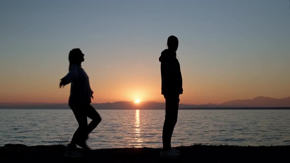 Silhouette of Loving Couple Against Sunset