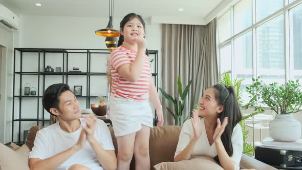 happiness pleasure asian lovely family enjoy watch tv and singing  dance practice together