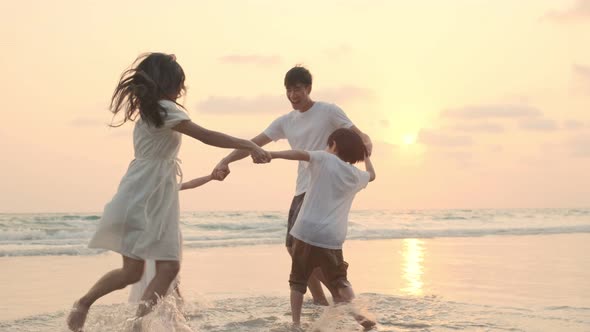 Asian Family playing together at beach with kids happy vacation travel beach concept