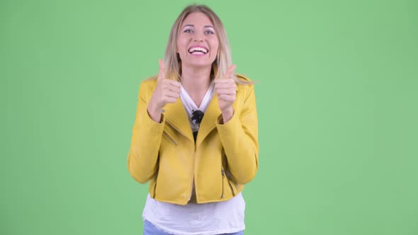 Happy Young Rebellious Blonde Woman Giving Thumbs Up and Looking Excited
