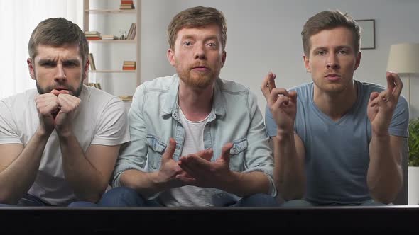 Superstitious Fans Praying for Favourite Team Winning, Holding Fingers Crossed