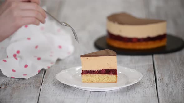 A Piece of Cherry Cake with Caramel Mousse on a White Plate