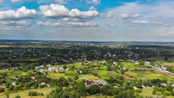 Hyperlapse of Village and Small Houses with Moving Clouds in Sky From a Flying Drone