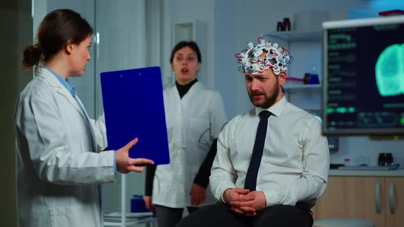 Neuroscience Doctor Showing on Clipboard Treatment Against Brain Disease